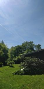 a building in a field with a kite in the sky at Victorian Summer House On Beautiful Natural Plot in Rønde