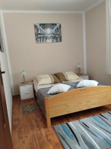 a bedroom with a bed and two night stands at Zacisze Sokolec in Ludwikowice Kłodzkie