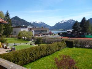 a garden with a view of a lake and mountains at Haus St_ Michael_ Ferienwohnung 1_4 in Schliersee
