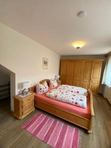 a bedroom with a large bed and a rug at Haus St_ Michael_ Ferienwohnung 1_4 in Schliersee