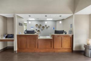 a waiting area in a dental office with wooden cabinets at Best Western Kenner in Kenner +54 photos
