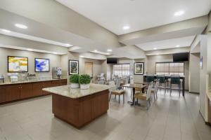 a lobby of a hospital with tables and chairs at Best Western Kenner in Kenner