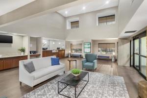 a living room with a couch and a table at Best Western Kenner in Kenner