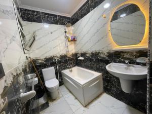 a bathroom with a sink and a toilet and a mirror at Sharo's House in Cairo