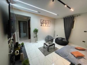 a living room with a tv and a couch at Sharo's House in Cairo