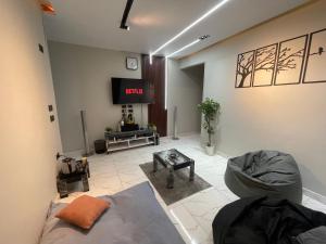 a living room with a tv and a couch at Sharo's House in Cairo