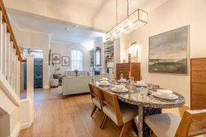 a dining room and living room with a table and chairs at Windsor Castle 4-Bed & Garden in Windsor