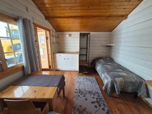 a room with a bed and a table in a room at Alta River Camping in Alta