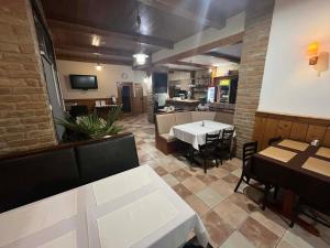 a restaurant with a table and chairs in a room at Hotel Brill Orosháza in Orosháza