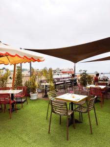 a group of tables and chairs on a patio at Ancestral Hostel Barranco in Lima