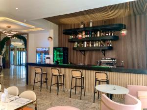 a bar with chairs and tables in a restaurant at Cathelea Convention & Suites in Benin City