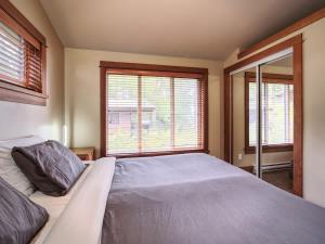 a bedroom with a bed and a large window at Going Coastal A - Oceanfront - Pet Friendly in Port Renfrew