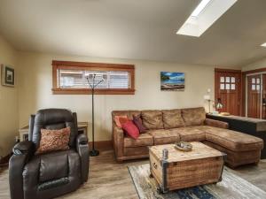 a living room with a couch and a chair at Going Coastal A - Oceanfront - Pet Friendly in Port Renfrew +16 photos