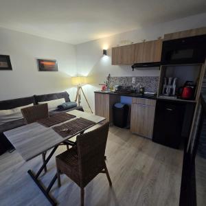 a kitchen and dining room with a table and chairs at Studio avec Terrasse in Arles