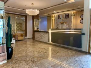 a lobby with a large projection screen on the wall at Cathelea Convention & Suites in Benin City +37 photos