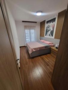 a bedroom with a bed in the middle of a room at Master apartman in Podgorica