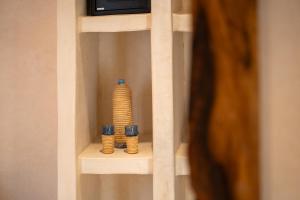 a shelf with two vases on top of it at Riad JAIA in Marrakesh