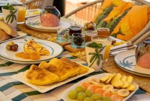 a table with plates of breakfast food on it at Riad JAIA in Marrakesh