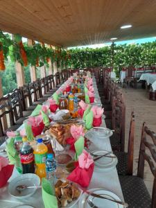 a long table with plates of food on it at Riverside Cottage in Martvili