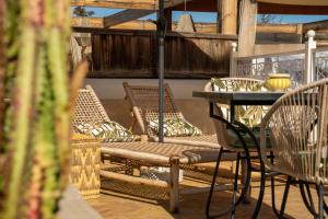 a patio with chairs and a table on a deck at Riad JAIA in Marrakesh
