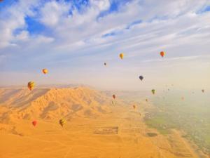 a bunch of hot air balloons flying in the sky at New Alsalam Hotel in Luxor +36 photos