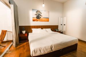a bedroom with a large white bed in it at Vaigayi Ayurveda and Yoga Resort in Kodanad