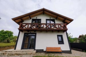 a small house with a wooden roof and a bench at Jenta in Kyiv