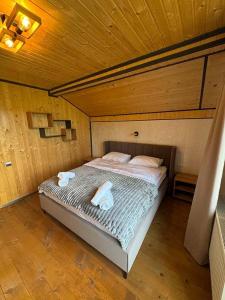 a bedroom with a bed with two towels on it at Jenta in Kyiv