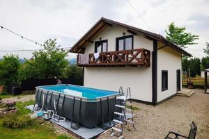a small house with a swimming pool in front of it at Jenta in Kyiv