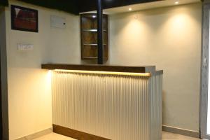 a room with a white wall with a metal fence at Suthanthira stay Inn in Dindigul