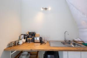 a kitchen counter top with a sink and a counter top at Five Elements Resort - Dome Glamping Tent in Harkerville