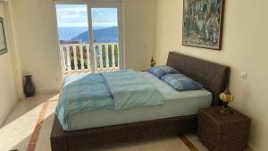 a bed in a bedroom with a balcony with a window at Villa royal in Alanya +35 photos