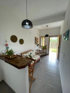 a living room with a table and a couch at Vila Pimenta Rosa in Caraíva