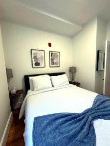 a bedroom with a large bed with a blue blanket on it at Downtown Providence FREE parking in Providence