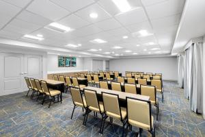 an empty room with rows of chairs in a classroom at Hampton Inn & Suites New Castle, PA in New Castle +61 photos