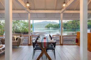 a living room with a view of a river at joe Dive resort in Pulau Lembeh