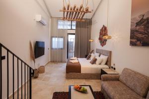 a living room with a bed and a couch at DUNIA Desert Suites in Mitzpe Ramon
