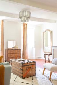 a living room with an old trunk and a mirror at Maison Sumiane - Maison d hotes et locations avec piscine in Brignoles