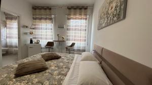 a bedroom with a bed and a bathroom at Comfort Accommodation Suite & Le Camere in Bergamo