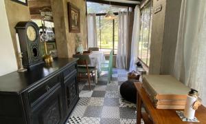 a living room with a clock and a table at Marble Nights Damoi Parys in Vosburg