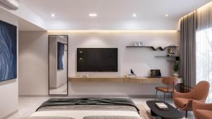 a bedroom with a bed and a tv on a wall at Hotel Presidency in Surat