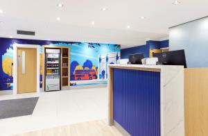 an office with blue walls and a counter with a refrigerator at Thistle London Park Lane in London