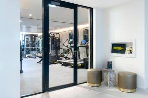 a gym with a glass door leading into a fitness room at Aldwark Manor Estate in Aldwark
