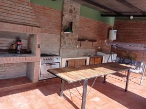 a kitchen with a wooden table and a stove at Lozano Casa de Campo in Lozano