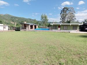 a house with a large yard in front of it at Lozano Casa de Campo in Lozano