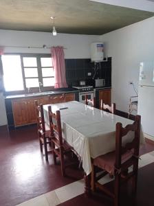 a kitchen with a table with a white table cloth on it at Lozano Casa de Campo in Lozano +2 photos