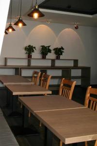 a dining room with tables and chairs and potted plants at Sadama kvartal in Pärnu