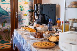a table with breads and pastries on it at Le Chele - A Due Passi dal Mare in Torre Lapillo