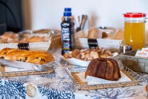 a table topped with bread and pastries and other foods at Le Chele - A Due Passi dal Mare in Torre Lapillo
