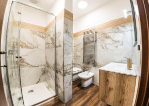 a bathroom with a shower and a toilet and a sink at Paladini al Casale in Piazza Armerina +54 photos